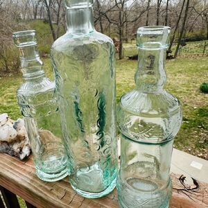 Set of Three Vintage Glass Bottles. Made in Spain. Light green tint.